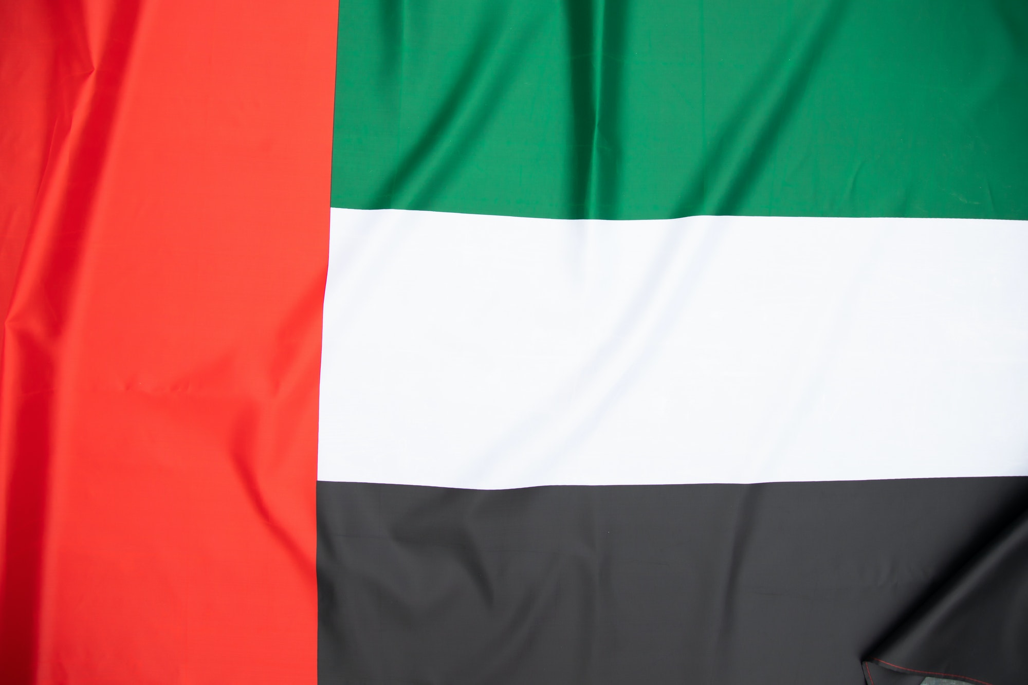 United Arab Emirates flag blowing in the wind. Background texture.